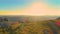 AERIAL: Unrecognizable mountain biker sits and observes the beautiful nature.