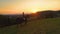 AERIAL: Unrecognizable young woman riding her horse on a scenic sunny evening.