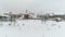 AERIAL. Unveiling drone shot above Neris river and Kaunas old town covered with snow in winter. People having fun with sleighs