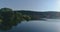 AERIAL. Unveiling drone shot of the lake in Lithuania on a sunny day