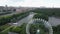 An aerial urban view with a green park area with a Ferris wheel in it