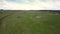 Aerial vast meadow with green grass stretches to horizon