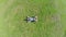 Aerial vertical shot of happy male lying on grass, zoom-out