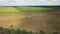 Aerial video from drone to agricultural field with harvesters.