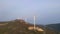 Aerial video of a group of wind turbines standing on hills