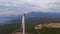 Aerial video of a group of wind turbines standing on hills