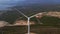 Aerial video of a group of wind turbines standing on hills