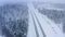 Aerial video Many cars driving on winter highway, forest, field, no sun, heavy snowfall, typical