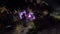 Aerial video of Musical fountain lit with purple light at night in the park