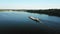 Aerial video river pusher boat transporting barge with dry cargo in middle of summer river, Central Europe