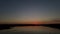 Aerial video Shooting from a quadcopter. Sunset over a huge lake where fishermen fish in boats.