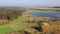 Aerial video of typical european breeding pond. Beautiful country with fields, forests and ponds