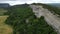 Aerial viev of lush green farm field with rocky cliffs in the distance. beauty of rural areas and the agricultural