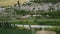 Aerial viev of lush green farm field with rocky cliffs in the distance. beauty of rural areas and the agricultural