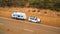 Aerial View of 4WD vehicle and modern caravan parked beside a highway in outback Australia