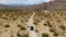 Aerial view of 4x4 car driving off road in the desert. Joshua Tree