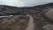Aerial view 4x4 car driving on winding road discovering wilderness of Iceland highlands. Drone view offroad vehicle