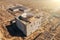 Aerial view of abandoned and ruined Nuclear Power Plant. Huge building with round whole for reactor in roof without celling