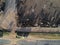 Aerial view of aberdeen angus cattle on confinement with tractor for feed distribution stopped on a farm