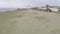 Aerial view above empty beach with straw parasols, deserted coastline in Cyprus