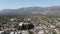 Aerial view above Pasadena neighborhood with mountain on the background. California