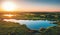 Aerial view above summer forest and lake at sunset, beautiful nature landscape panorama