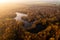 Aerial view above Walton Colliery Nature Park with Autumn woodland and lake in Wakefield