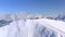 Aerial view from above winter mountain resort. People skiing and snowboarding on snow slope in winter ski resort. Drone view ski e