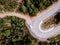 Aerial view of an adventure travel motorhome on a mountain road through a forest