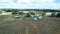 Aerial view of agricultural farm sheds and hay storage bays on farmland with eucalyptus gum trees, New South Wales, Australia