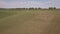 AERIAL VIEW. Agricultural field after harvest. Hay bales on the field during harvest and farming season. 4K