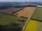 Aerial view of agricultural fields of different color crop under