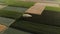 Aerial view with agricultural fields and orchards intersected by narrow roads.