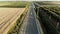 Aerial view with agricultural fields and orchards intersected by narrow roads.