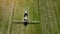 Aerial view of agricultural sprayer working on the green field on a sunny day