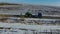 Aerial view of agricultural vehicles on a trawl in winter.