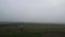 Aerial view of agriculture lands covered in fog