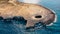 Aerial view of Ahrax fallen cave,Coral Lagoon,Malta.Hole in the middle of rocks with crystal clear water inside.Rocky Maltese