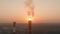 Aerial view of air polluting smoke stack at sunset