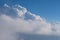 Aerial view from airplane of rain clouds and blue sky