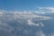 Aerial view from airplane of rain clouds and blue sky