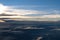 Aerial view from airplane of rain clouds and blue sky in twilight