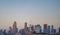 Aerial view of an airplane soaring above an Tokyo with tall buildings in the background