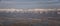 Aerial view from airplane of the Wasatch Front Rocky Mountain Range with snow capped peaks in winter including urban cities of Pro