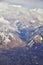 Aerial view from airplane of the Wasatch Front Rocky Mountain Range with snow capped peaks in winter including urban cities of Pro