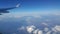 Aerial view from airplane window of beautiful clouds and blue sky