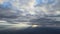 Aerial view from airplane window at high altitude of earth covered with white thin layer of misty haze and distant