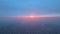 Aerial view from airplane window at high altitude of earth covered with white thin layer of misty haze and distant