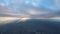 Aerial view from airplane window at high altitude of earth covered with white thin layer of misty haze and distant