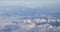 Aerial View From Airplane Window On Snowy Top Of Tatra Mountains In Summer Day. High Attitude